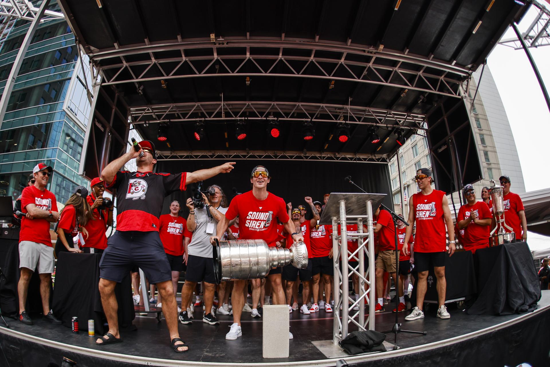 Members of the Carolina Hurricanes celebrate the team's Stanley Cup victory during a post-championship victory rally.
