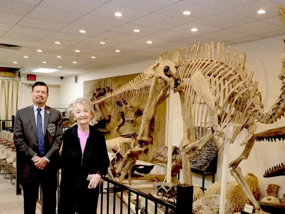 Two people pose with artifacts