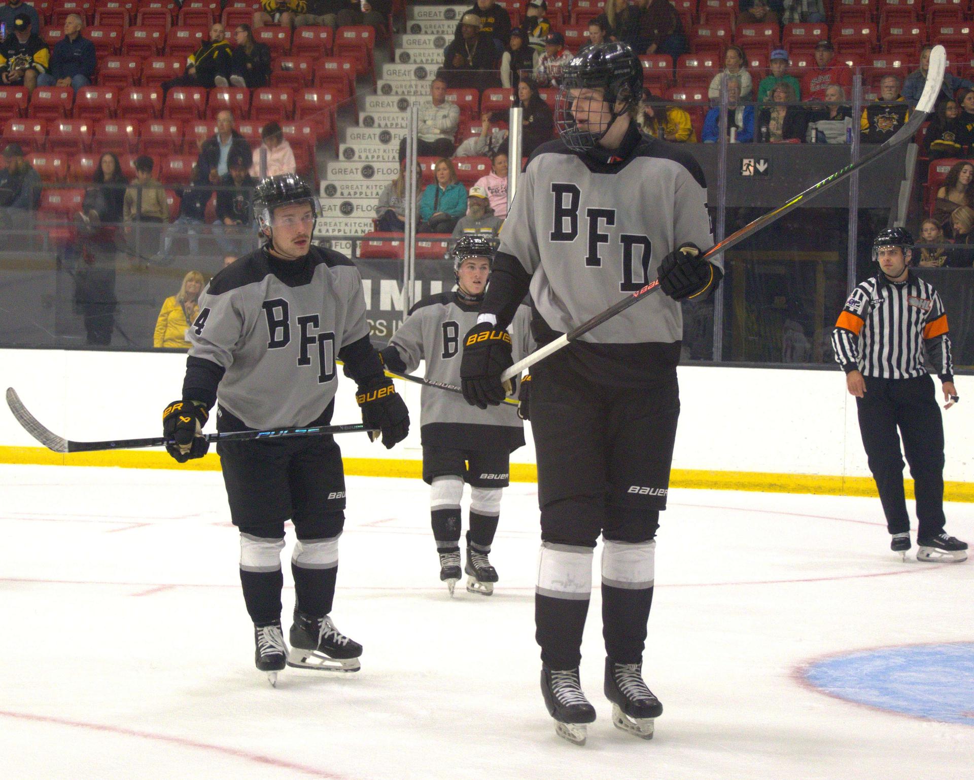 Defenceman Alexander Karmanov towers over his Brantford Bulldogs teammates on the ice. 