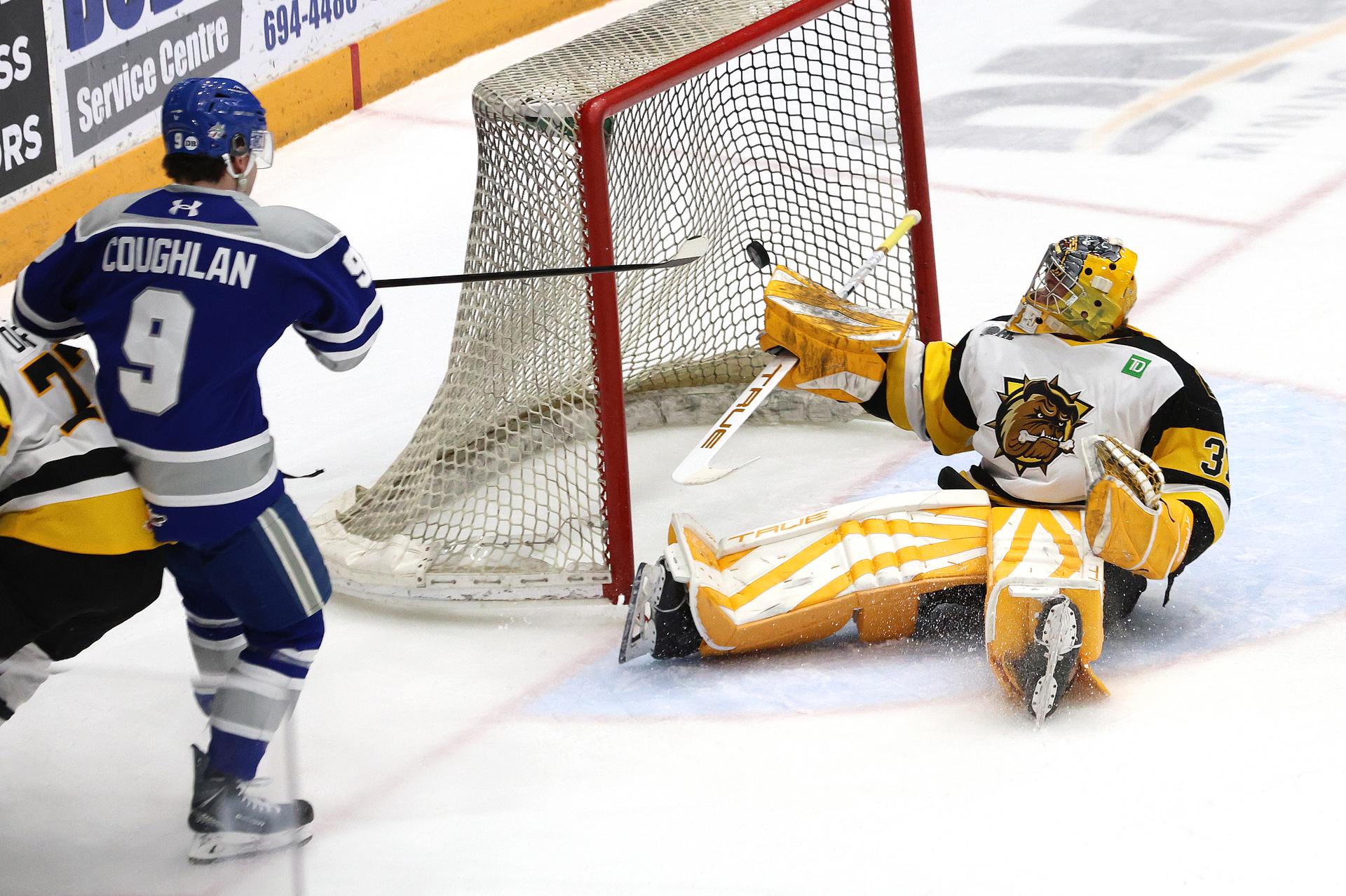 Brantford Bulldogs goaltender Ryerson Leenders is seated on his bottom as the puck heads into the net during a game against the Sudbury Wolves.