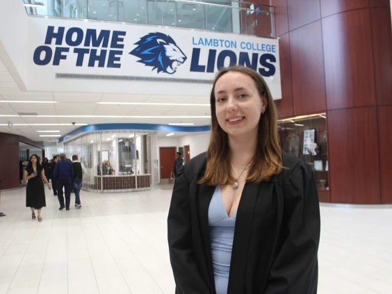 A Lambton College graduate smiles