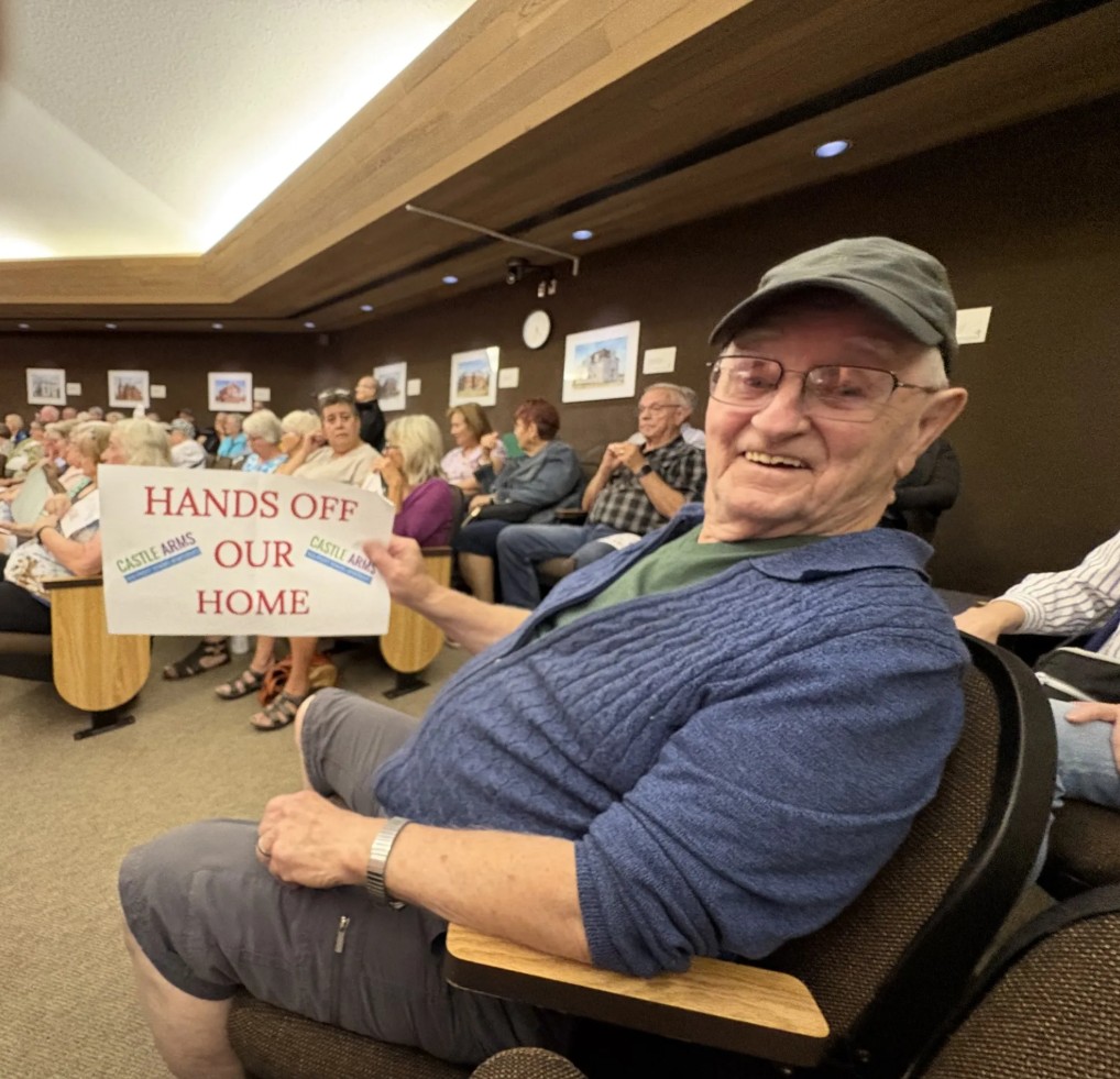 man holds up protest sign