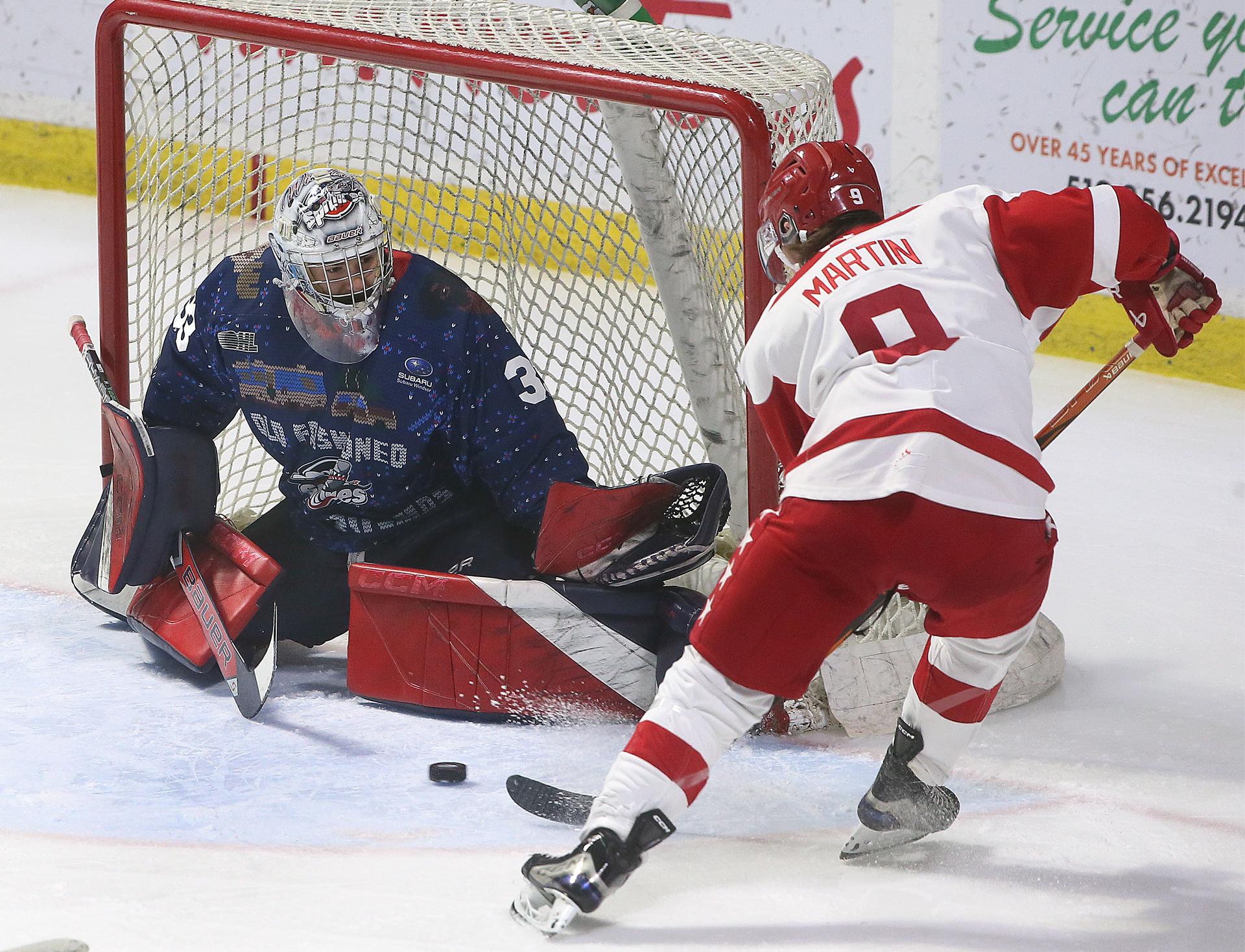 Windsor Spitfire goalie Joey Costanzo makes a save on Soo Greyhounds forward Jeremy Martin.