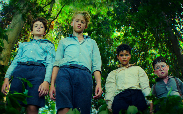 A still of four kids from LORD OF THE FLIES.