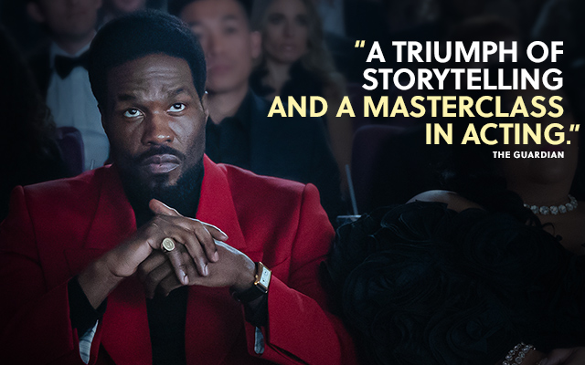 A person in a theater in Marvel Television WONDER MAN. Text over reads: 'A triumph of storytelling and a masterclass in acting.' The Guardian.