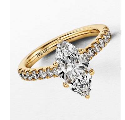 Yellow gold engagement ring with a marquise-cut diamond center stone and pavé diamond band.