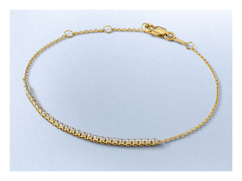 A yellow gold tennis bracelet with a curved row of round diamonds.