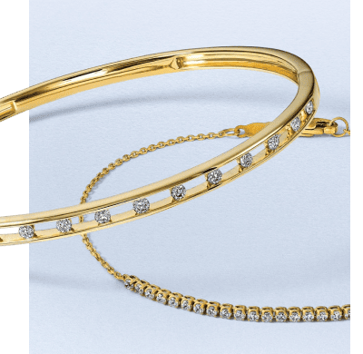 Yellow gold bracelets featuring round diamond details and a diamond tennis chain.