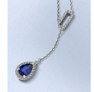 Silver-tone necklace with a pear-shaped blue topaz pendant, halo and diamond-accented link.