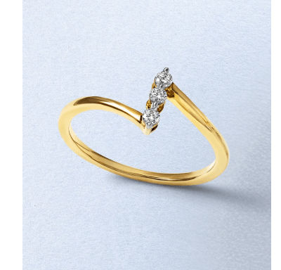A yellow gold ring featuring a trio of round diamonds in a diagonal setting.