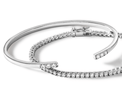 White gold bangle bracelet with diamond accents and diamond tennis bracelet.