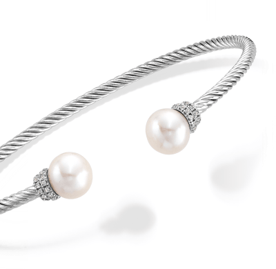 Cable bangle bracelet in sterling silver with freshwater pearl ends and diamond accent caps.