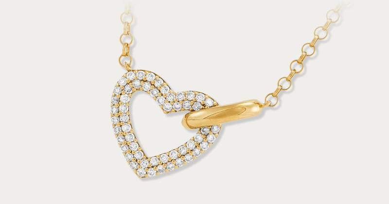 Yellow gold open-heart pendant with pavé diamond accents on a dainty chain.