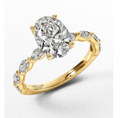 Yellow gold engagement ring with an oval-cut diamond center stone and marquise-shaped diamond accents.