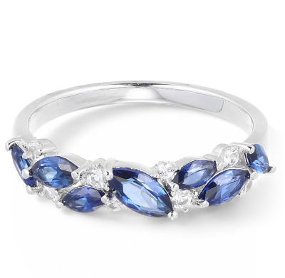 A blue sapphire and diamond band ring in white metal.