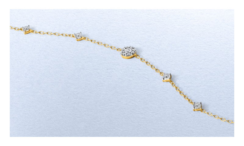 Yellow gold diamond station bracelet featuring alternating round-cut diamonds.