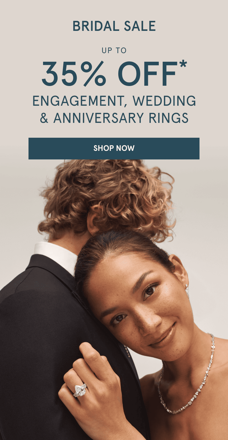 Bride wearing a diamond ring and bridal jewelry while embracing her partner. Bridal sale. Up to 35% Off rings. Click shop now.