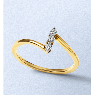 A yellow gold ring featuring a trio of round diamonds in a diagonal setting.