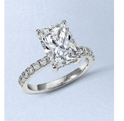 Radiant-cut diamond engagement ring with a white gold band and diamond accents.