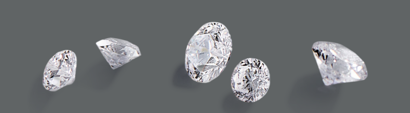 Five loose diamonds in assorted cuts.