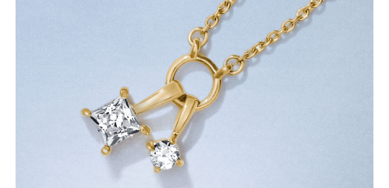Yellow gold necklace with two charm pendant diamonds.