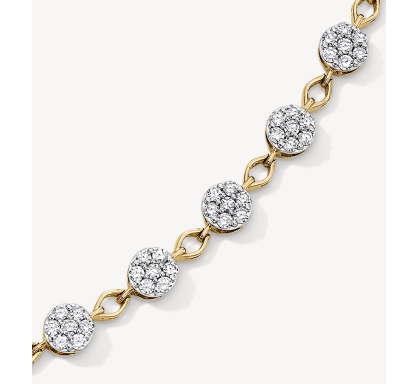 A yellow gold station bracelet featuring round diamond cluster links.