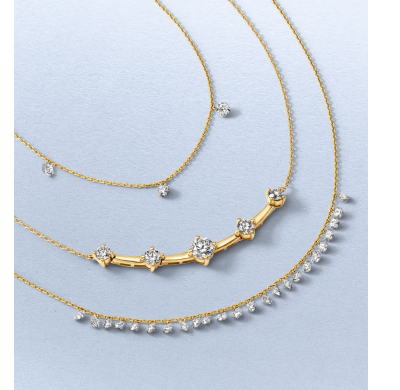 Layered yellow gold necklaces featuring round diamond stations and diamond-accented links.