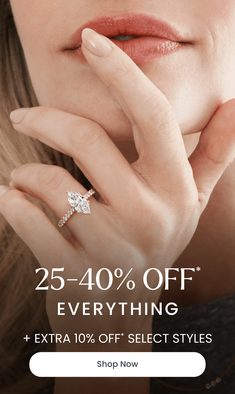 A model wearing a marquise diamond ring. 25-40% off everything + extra 10% off select styles. Click shop now.