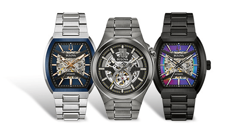 Three Bulova Maquina automatic watches featuring silver, black and blue designs with open-heart dials.