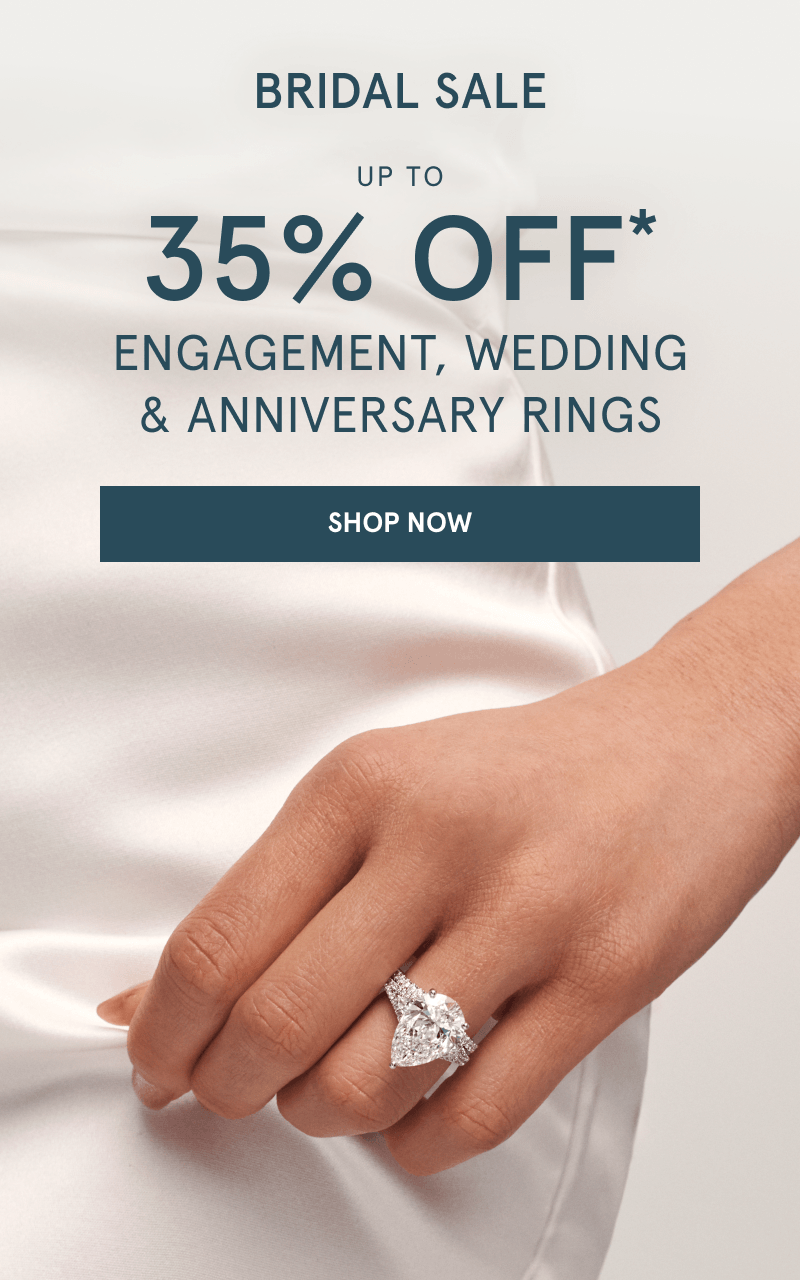 Pear-shaped diamond engagement ring with a pavé diamond band on hand. Bridal sale. Up to 35% Off rings. Click shop now.