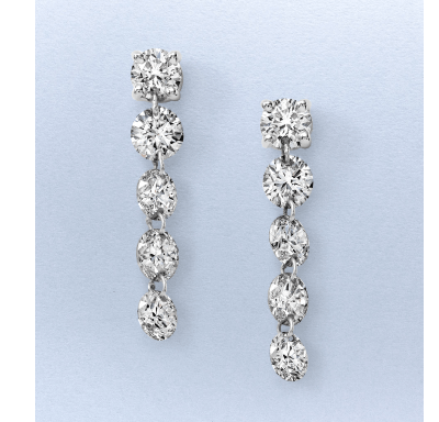 White gold drop earrings featuring round and oval diamonds in a cascading design.
