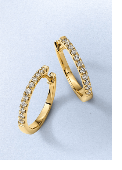 Yellow gold hoop earrings accented with a row of round diamonds.