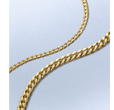 Yellow gold curb chain necklace with polished links displayed on a light background.