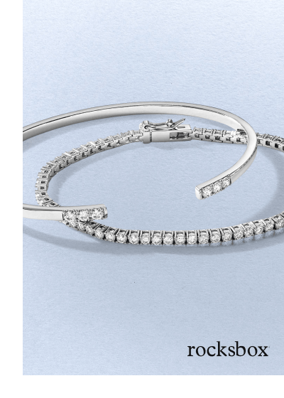 A white gold diamond tennis bracelet paired with an open diamond-accented cuff bracelet.