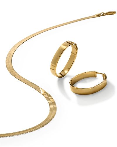 Yellow gold herringbone chain necklace and yellow gold smooth hoop earrings.