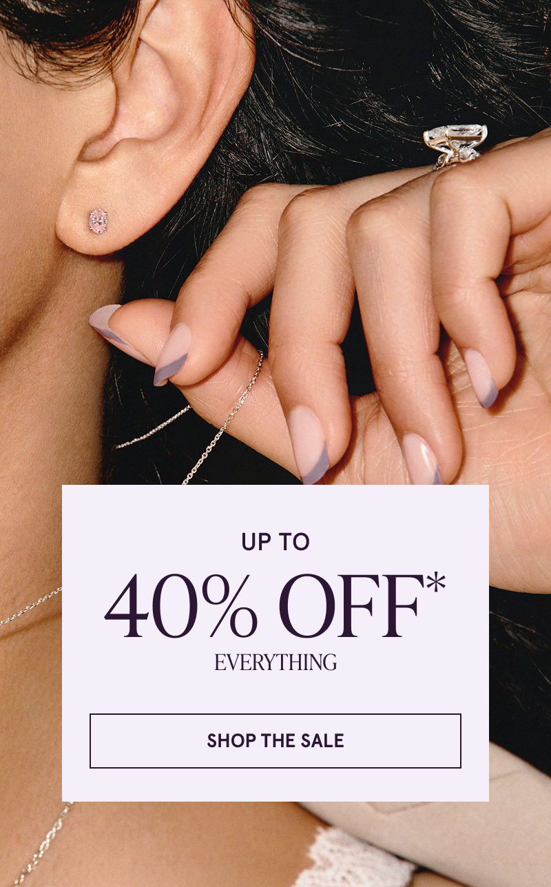 Focus on model’s engagement ring & pink gemstone stud. Up to 40% OFF everything. Click here to shop the sale