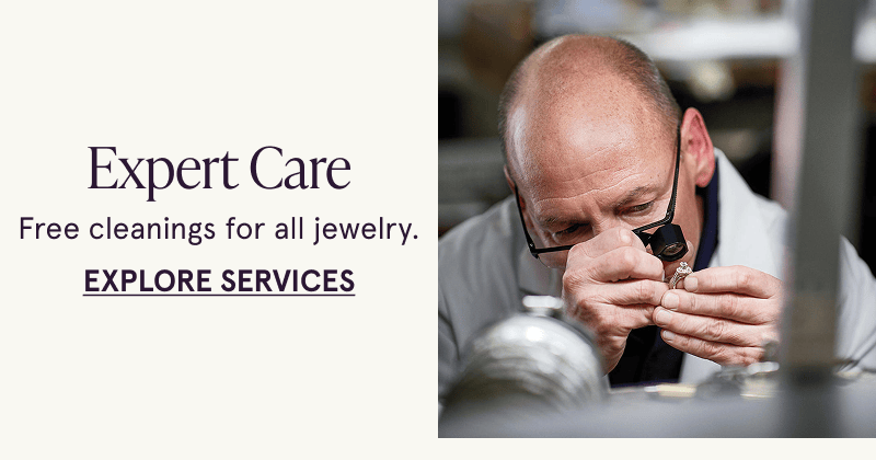 A Jewelry Expert inspects a ring. Free cleanings for all jewelry. Click here to explore services
