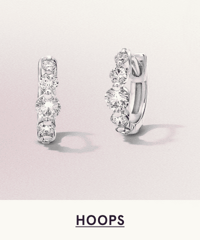 A pair of white metal diamond hoops. Click here to shop hoops