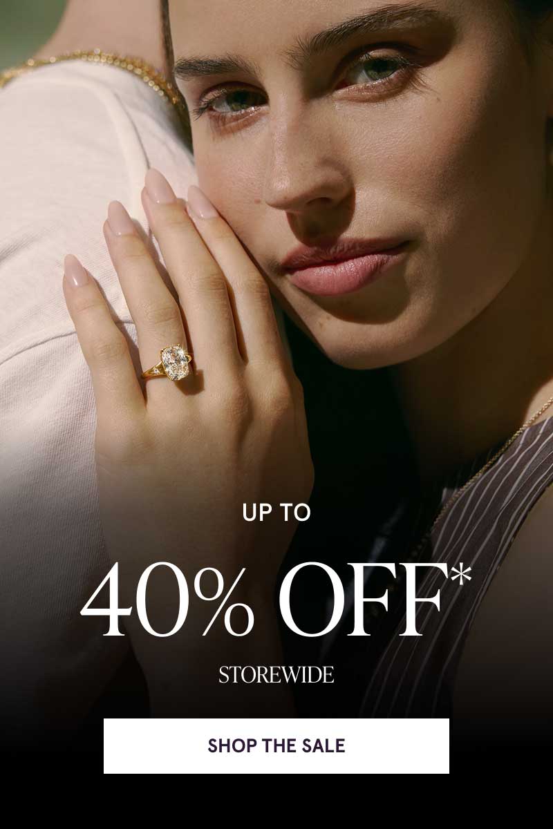 Female with gold cushion cut diamond ring resting against partner. Up to 40% OFF Storewide. Click here to shop the sale