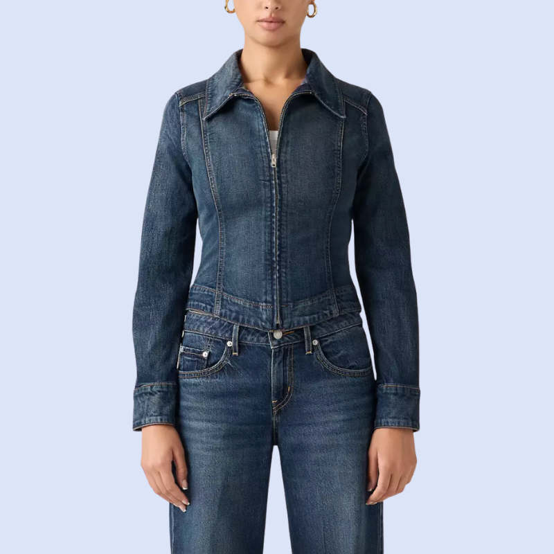 A model wearing a dark wash denim jacket and matching jeans