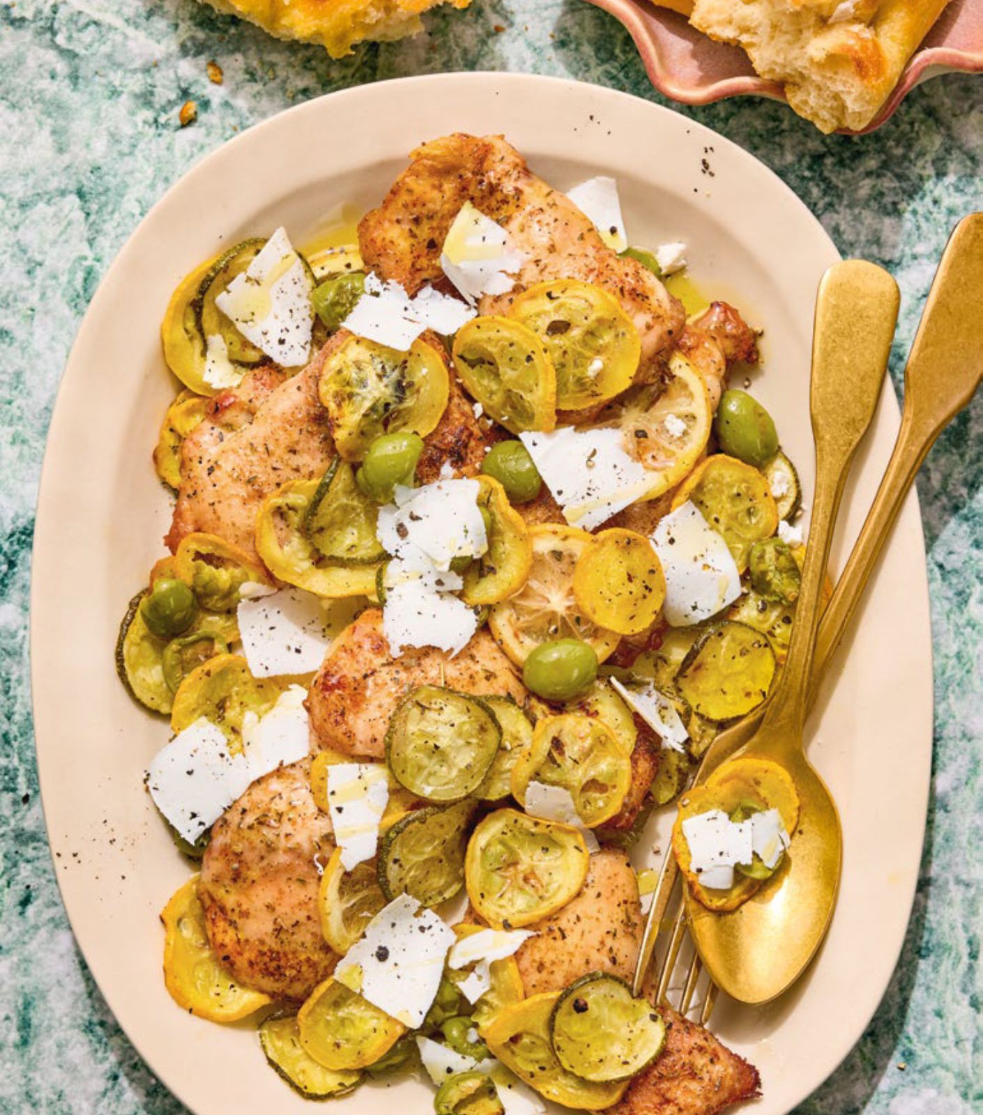 A platter of squash and chicken thighs.