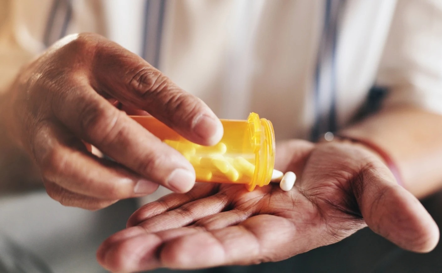 hands holding a pill bottle