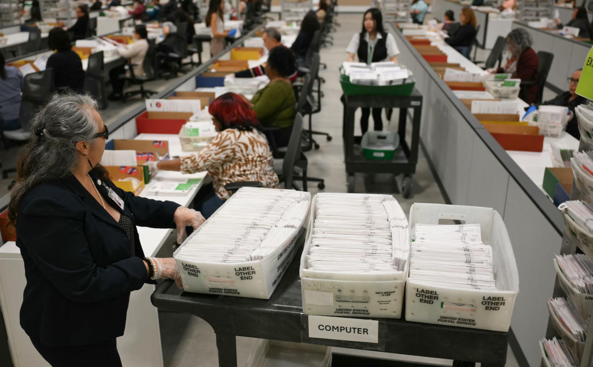  US-POLITICS-CALIFORNIA-VOTE An election worker moves mail-in ballots to be organized for tabulation at the Los Angeles County Ballot Processing Center