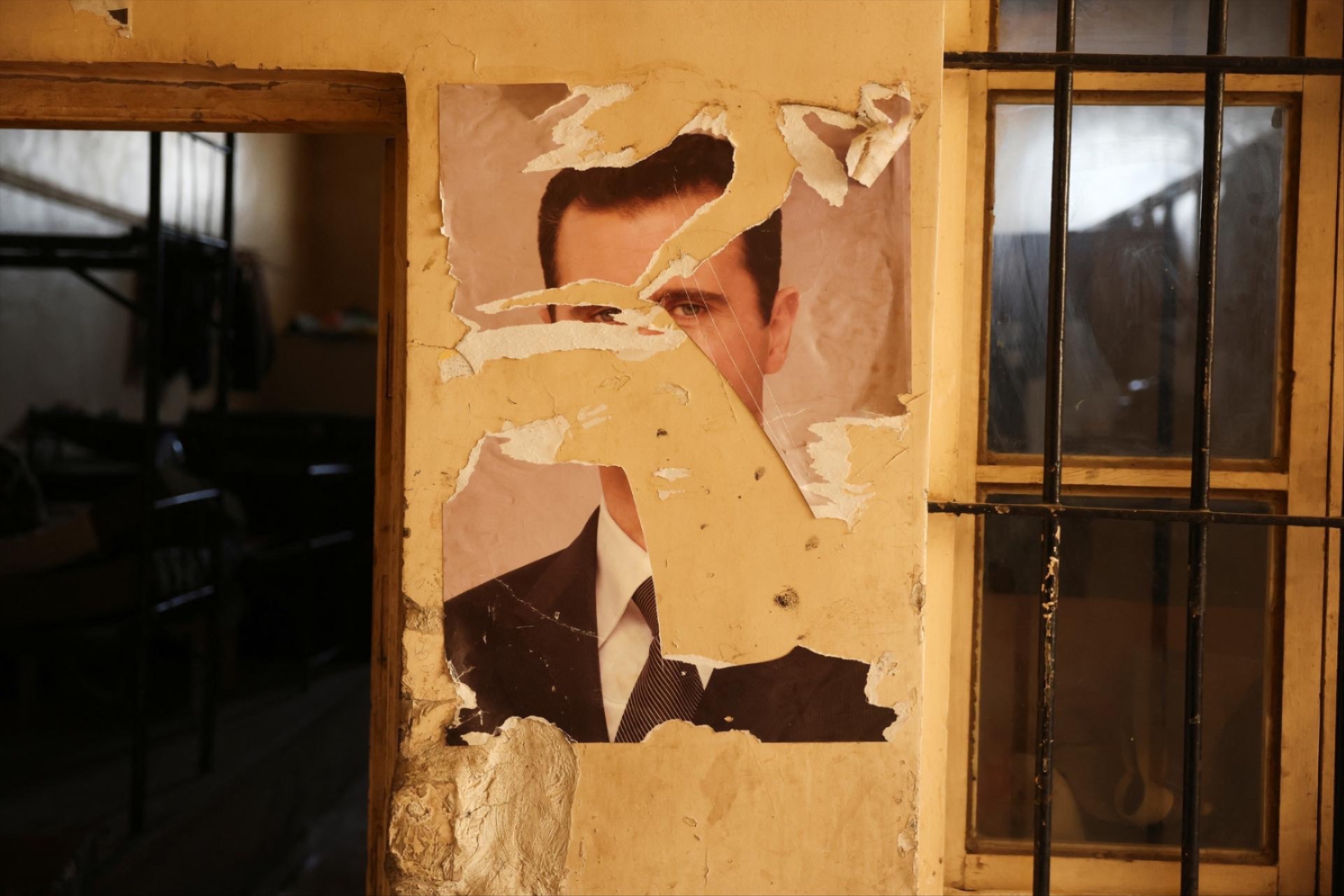 A damaged portrait of former Syrian President Bashar al-Assad at a military base in Damascus, Syria, December 15, 2024.