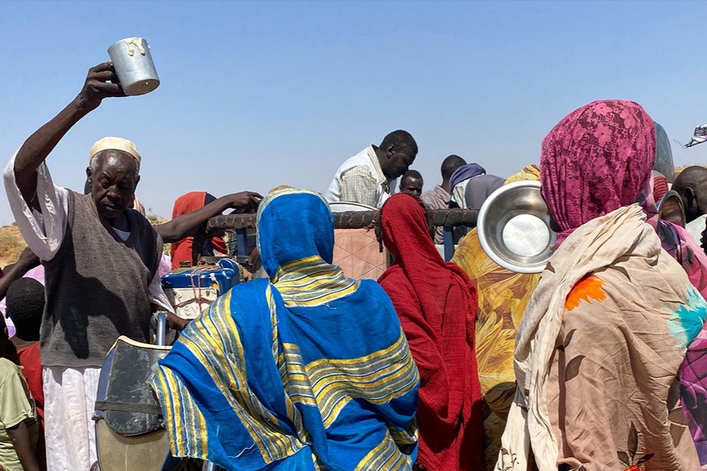 Sudanese who fled El Fasher after paramilitary forces killed hundreds of people in the western Darfur region, crowd to receive food at their camp in Tawila, Sudan, Sunday, Nov. 2, 2025.