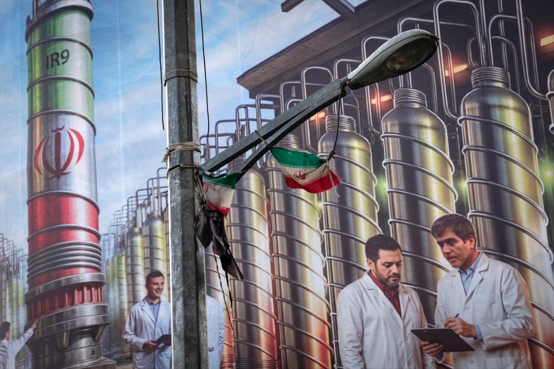 A giant banner featuring symbolic images of the Natanz nuclear enrichment facility, Iranian nuclear scientists killed in Israeli attacks during the 12-day war, and a Persian script that reads, ”Science is power,” hangs from a governmental building in downtown Tehran, Iran, on August 28, 2025. 