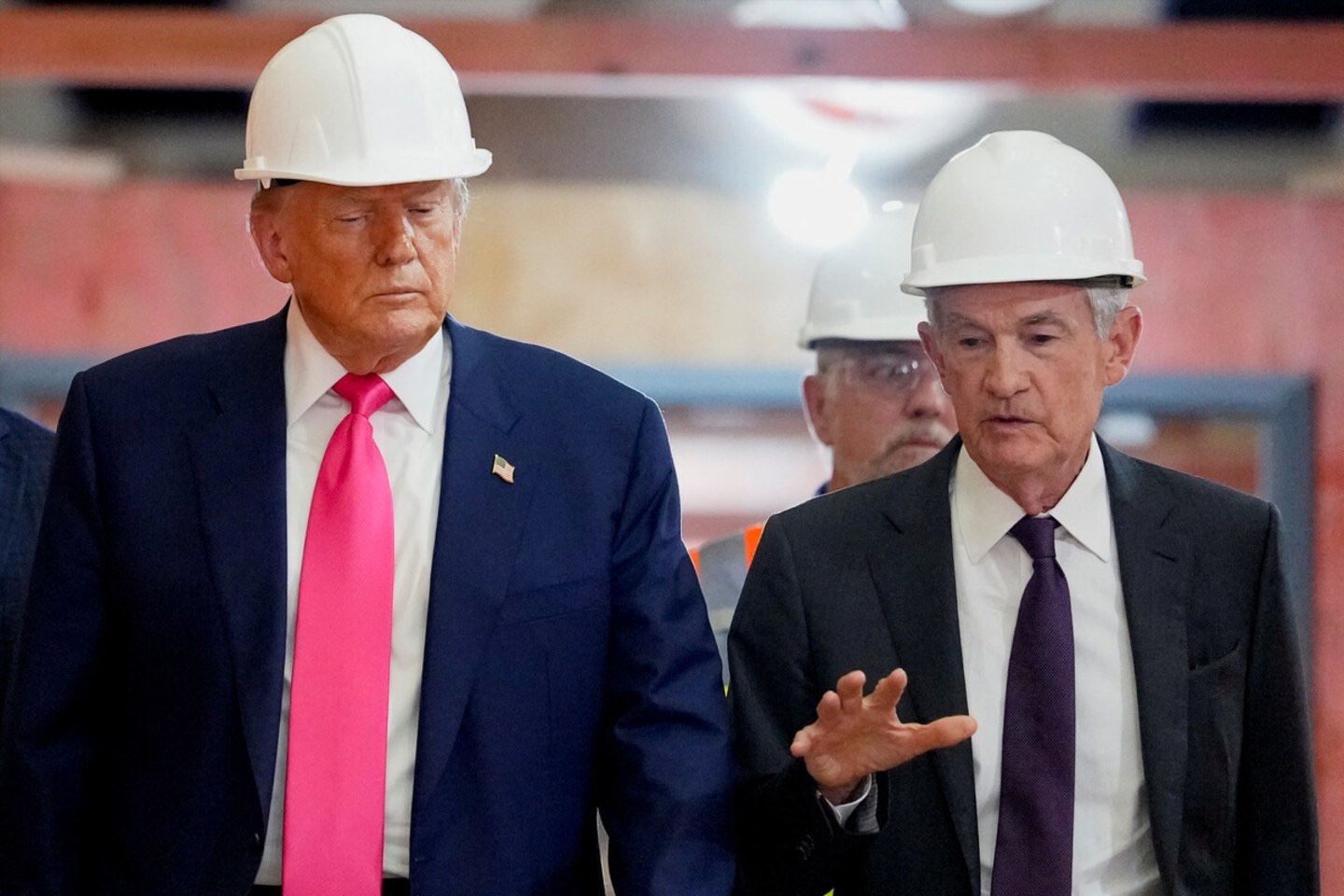 Donald Trump and Fed Chair Jerome Powell walk through the Federal Reserve building on July 24 as it undergoes renovations.