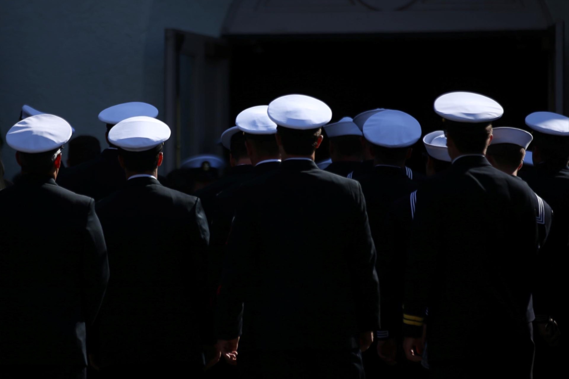 U.S. Navy sailors make their way into church. 