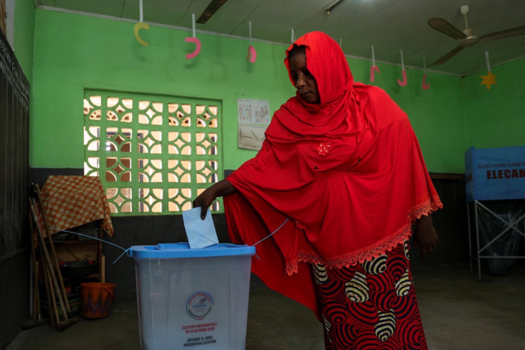 A woman casts her vote on the day of Cameroon's presidential election at a polling station in Garoua, Cameroon on October 12, 2025.
