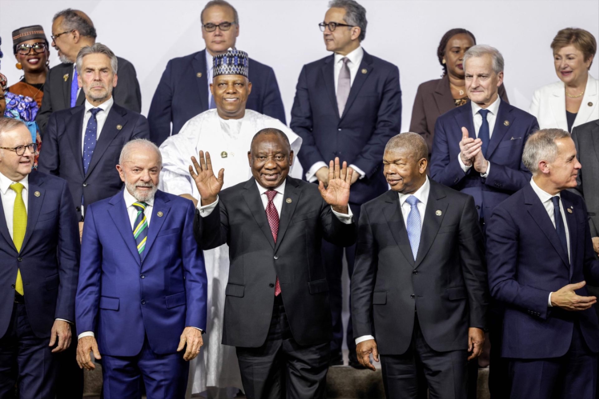World leaders, including South African President Cyril Ramaphosa, react as they attend a family photo event during a G20 Leaders' Summit plenary session at the Nasrec Expo Centre in Johannesburg, South Africa, November 22, 2025. 